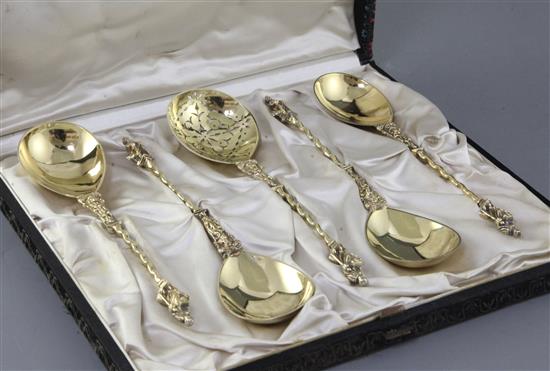 A cased set of four Victorian silver gilt apostle serving spoons and matching sifter spoon by Robert Harper, 7.5 oz.